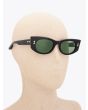 Akoni Aquila Oval-Frame Black Acetate Sunglasses with mannequin three-quarter view